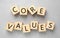Wooden cubes with phrase CORE VALUES on grey background, flat lay