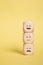 Wooden Cubes smilies faces symbols on yellow , Customer experience rating