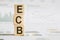 Wooden cubes with word ECB arranged in a vertical pyramid, on the light background. Business concept. ECB short for European