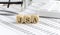 Wooden cubes with the word JSA - Joint Sales Agreemen stand on a financial background with chart, calculator, pen and glasses,