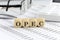 Wooden cubes with the word OPEC on a financial background with chart, calculator, pen and glasses, business concept