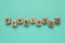 Wooden cubes with word Prebiotic on turquoise background, flat lay