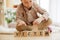 Wooden cubes with word VICTIM in hands of little boy