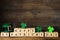 Wooden cubes with words HAPPY ST PATRICK`S DAY, green leprechaun hat and clover leaves
