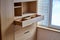 Wooden cupboard with opened drawer. Modern furniture