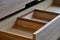 Wooden cupboard with opened drawer. Modern furniture