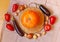 Wooden cutting board with pumpkin surrounded by vegetables