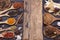 Wooden cutting board and spoons spices chili garlic salt kosher pepper on a dark wooden table. Top view with copy area