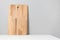 Wooden cutting board on table with linen tablecloth. Kitchen minimalist concept