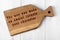 Wooden cutting board with wise inscription about food