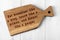 Wooden cutting board with wise inscription about food