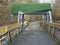 Wooden cycling bridge with green roof hood