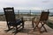 Wooden deck chairs on an elegant wooden deck with a sea view, Pacific Grove, CA.