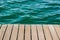 Wooden deck floor waterfront shoreline background texture material perspective foreshortening surface to blue water, wallpaper