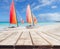 Wooden deck perspective with two colorful catamarans