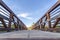 Wooden deck and rusty guardrails of a bridge against blue sky on a sunny day