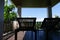 Wooden deckchair at the balcony with forest and sky view