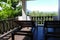 Wooden deckchair at the balcony with forest and sky view