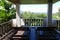 Wooden deckchair at the balcony with forest and sky view