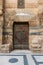 Wooden decorated copper plated door and stone bricks wall, Old Cairo, Egypt