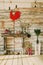 wooden decorative fireplace on which there are candles, flowers, willow branches, candle holder, oil lamp