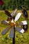 Wooden decorative flower and bee, sign of apiary or bee-garden near. Beekeeping warning signpost. Soft focused vertical closeup