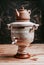 Wooden decorative samovar on a wooden table, rustic style