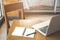 Wooden desk and chair with notepad. Pens and laptops