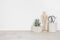 Wooden desktop with flower pot, human statuette and office supplies