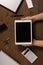 Wooden desktop with mans hands and tablet