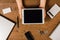 Wooden desktop with mans hands and tablet