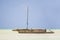 Wooden Dhow boat lying dry at low tide on a tropical beach