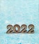 Wooden digits 2022. Numerals 2022 on blue background.