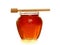 Wooden dipper with jar of honey.