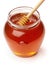 Wooden dipper with jar of honey.