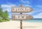 Wooden direction sign with lifeguard beach
