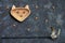 Wooden dish with treat for pets shaped in head cat and toy, dark background. Top view. Concept care, feed pets