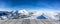 Wooden display shelf table top against blurred snow covered mountain panorama