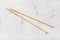 Wooden disposable chopsticks on concrete board