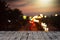 Wooden dock against a blurry background with heart-shaped city lights