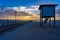 Wooden dock  with beautiful sunset at the background.