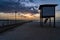 Wooden dock  with beautiful sunset at the background.