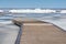 Wooden dock and a break wall on a frozen lake