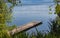 Wooden dock on a calm lake on beautiful summer morning, Okanagan Lake, Canada