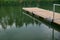 Wooden dock on a calm lake at the cottage in Montreal, Canada