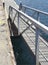 Wooden dock gangway and aluminum railing in marina. Port conditioning. Nautical background