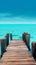 A wooden dock jetty pier with a tropical blue ocean summer sky background.