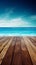 A wooden dock jetty pier with a tropical blue ocean summer sky background.