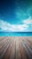 A wooden dock jetty pier with a tropical blue ocean summer sky background.