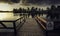 Wooden dock with a [Perigo - danger] sign on a river under a dark cloudy sky in the evening